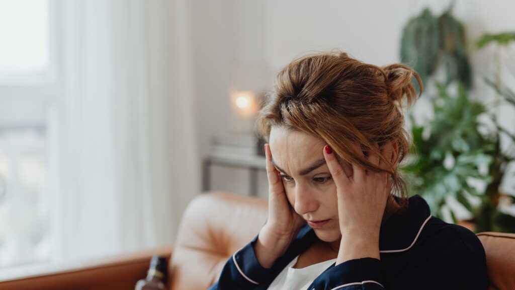 Woman holding her head as a symbolisation of stress