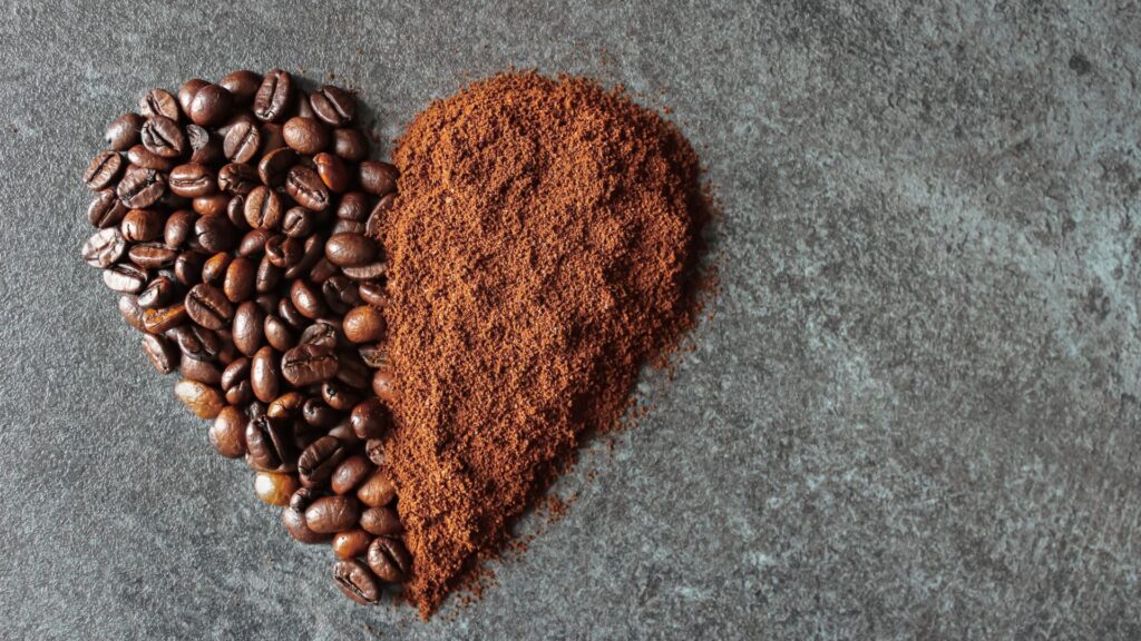 Shot of a heart, one half coffee beans, one half ground coffee